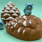 Snow Dusted Pine Cone Bath Bomb for Kids with Raccoon Figure Inside
