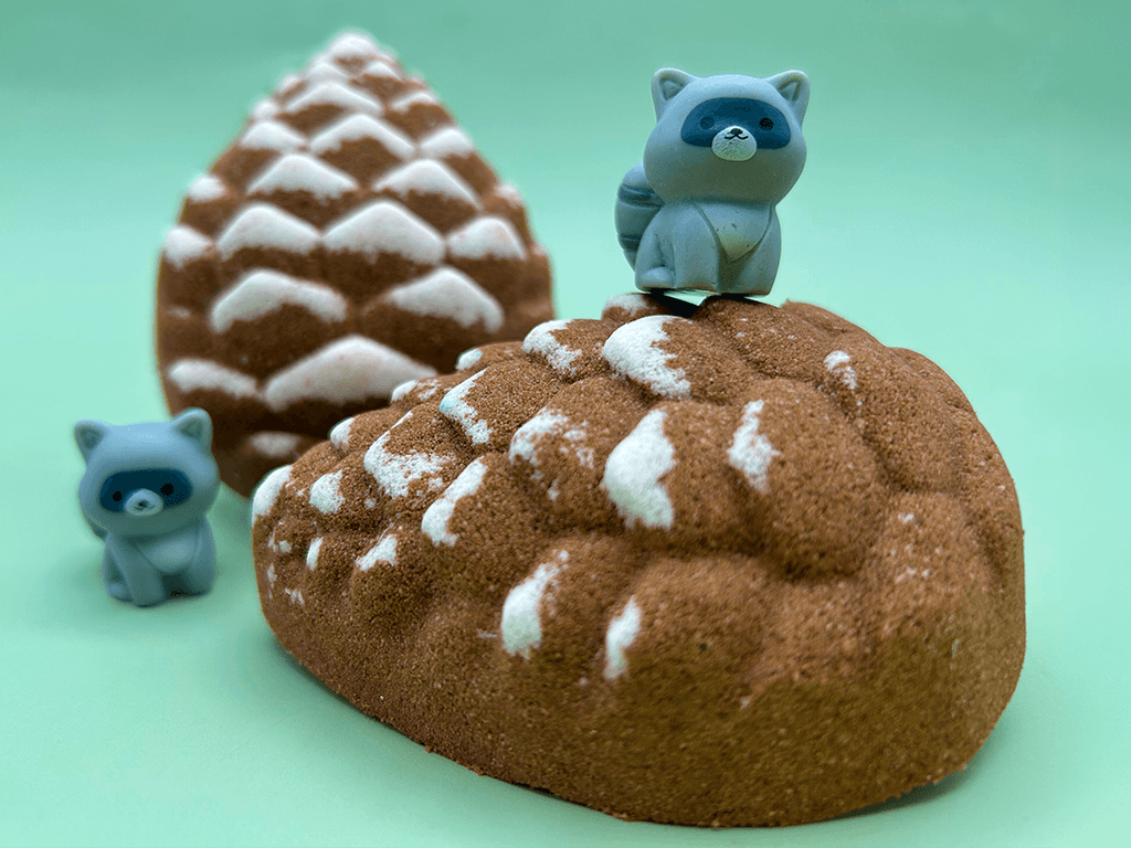 Snow Dusted Pine Cone Bath Bomb for Kids with Raccoon Figure Inside
