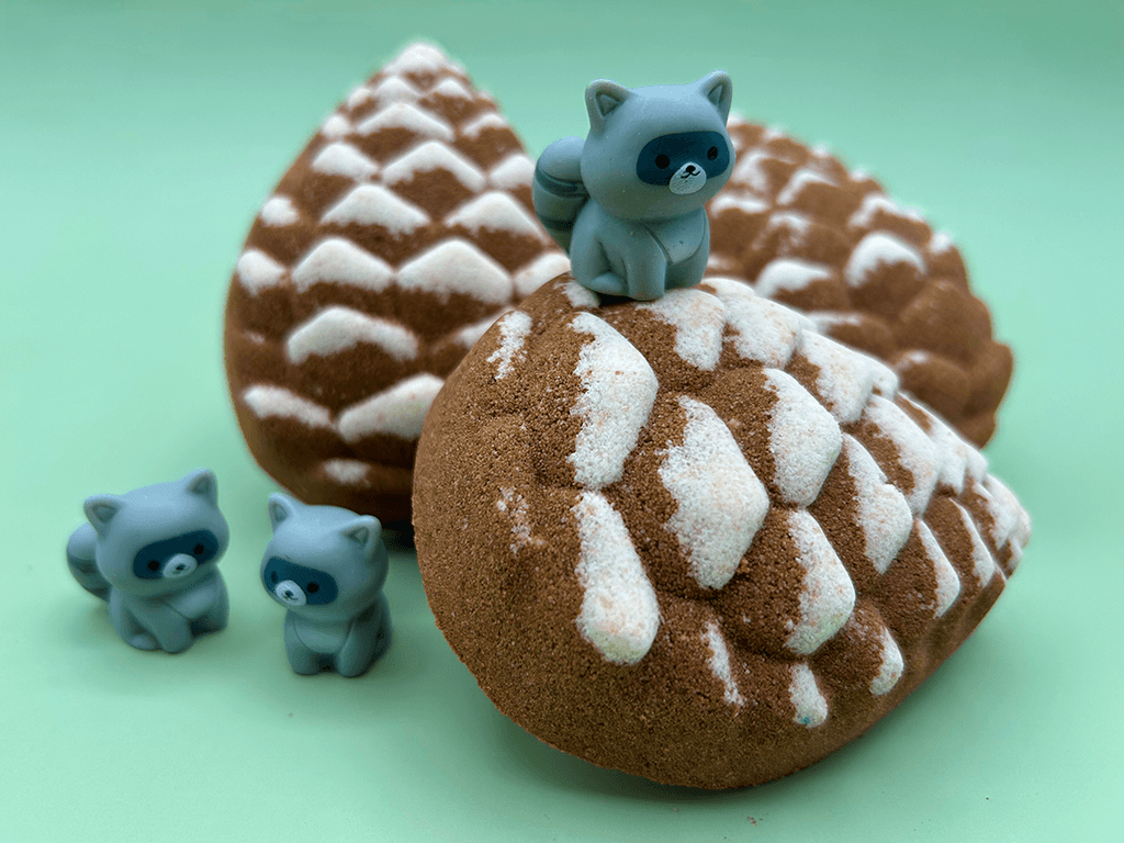 Snow Dusted Pine Cone Bath Bomb for Kids with Raccoon Figure Inside