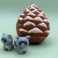 Snow Dusted Pine Cone Bath Bomb for Kids with Raccoon Figure Inside