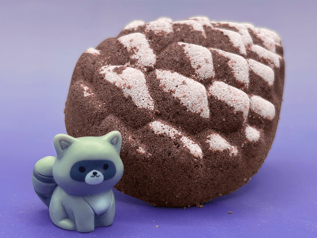 Snow Dusted Pine Cone Bath Bomb for Kids with Raccoon Figure Inside