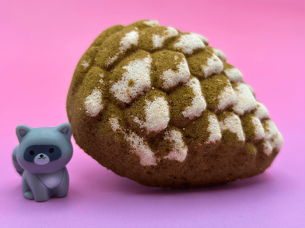 Snow Dusted Pine Cone Bath Bomb for Kids with Raccoon Figure Inside