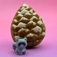Snow Dusted Pine Cone Bath Bomb for Kids with Raccoon Figure Inside