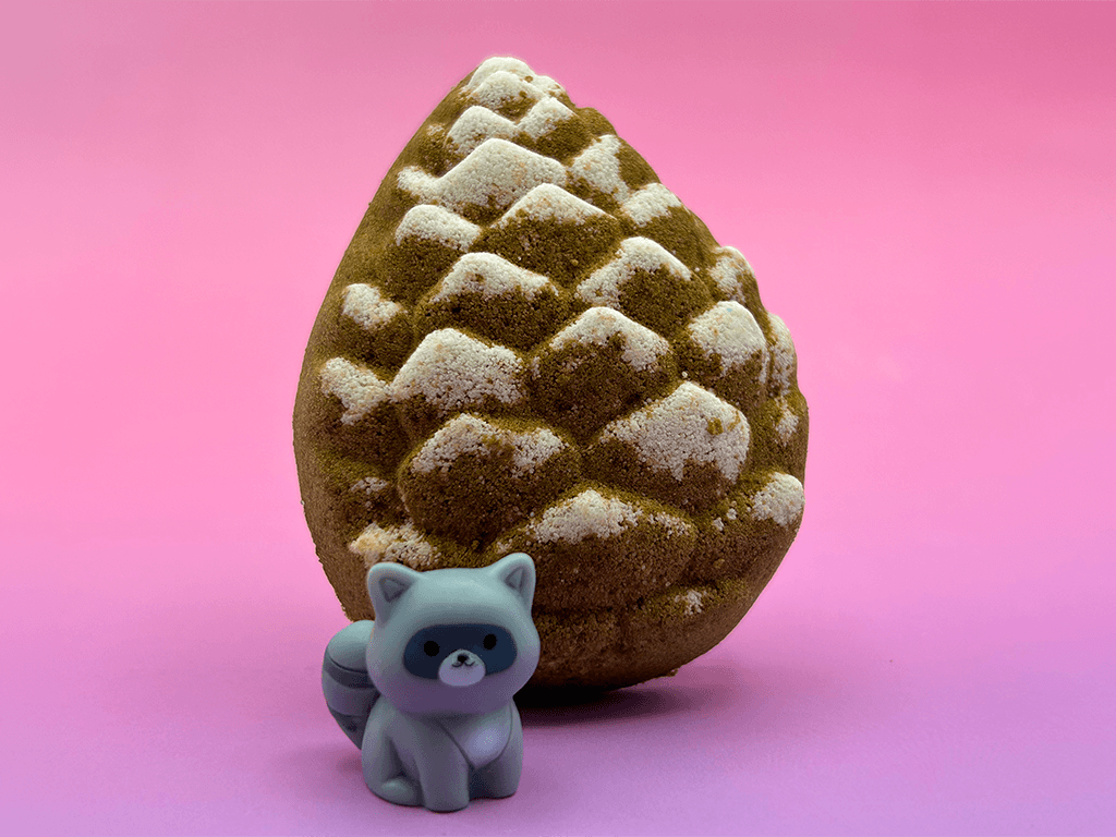 Snow Dusted Pine Cone Bath Bomb for Kids with Raccoon Figure Inside